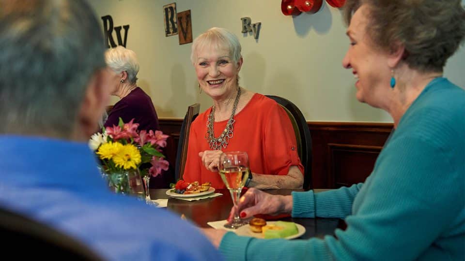 Senior Living residents of Redstone Village enjoying social hour