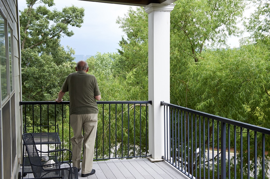 Resident standing on balcony with view of the mountains