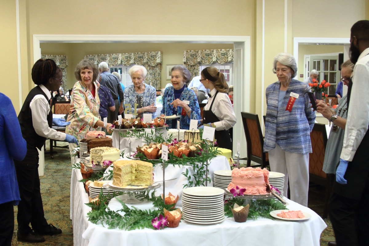 Redstone Village residents and employees admiring desserts at 15th anniversary celebration